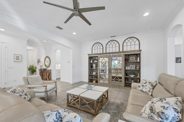 living room with ceiling fan, french doors, crown molding, and light tile patterned floors