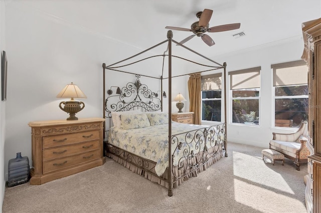 carpeted bedroom with ceiling fan and ornamental molding