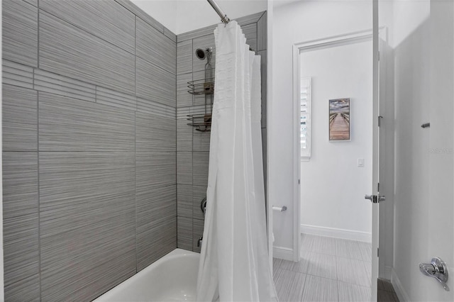 bathroom featuring tile patterned flooring and shower / bath combination with curtain