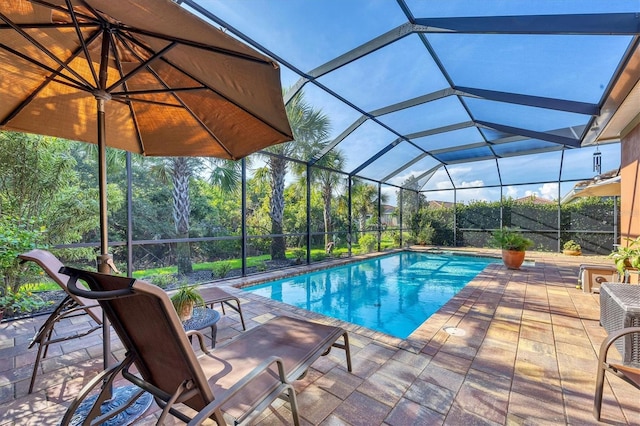 view of swimming pool with a patio and a lanai