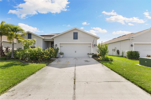 ranch-style home featuring a garage and a front lawn