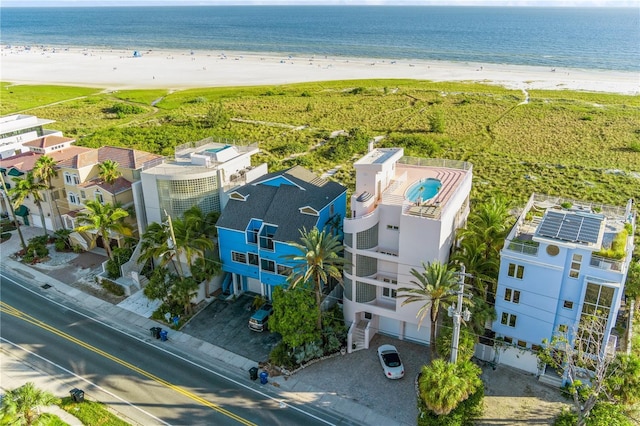 birds eye view of property with a water view and a view of the beach