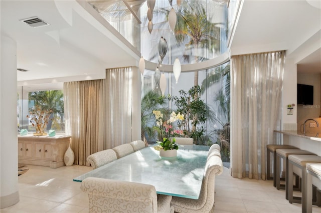 tiled dining area featuring visible vents