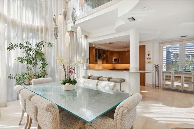 dining room featuring light tile patterned floors and visible vents