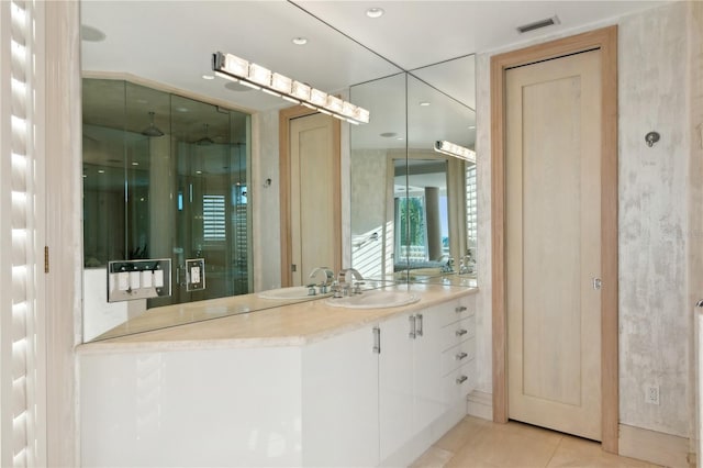 full bathroom with tile patterned flooring, vanity, and a shower stall