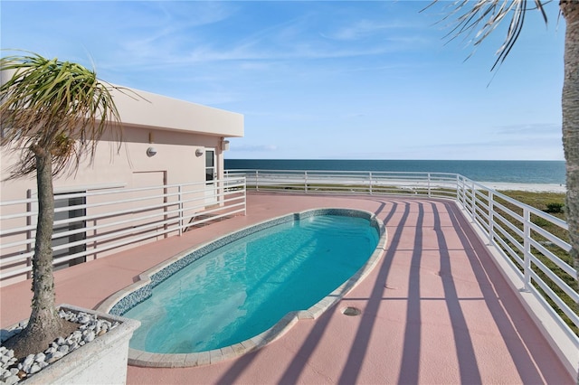 view of swimming pool featuring a water view