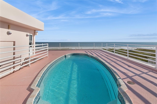 view of pool with a fenced in pool and a water view