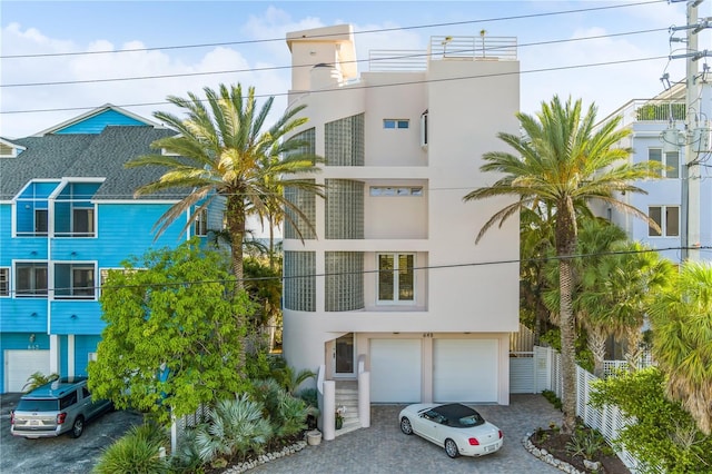 648 Beach Rd, Sarasota, FL 34242 - view of building exterior with driveway and a garage