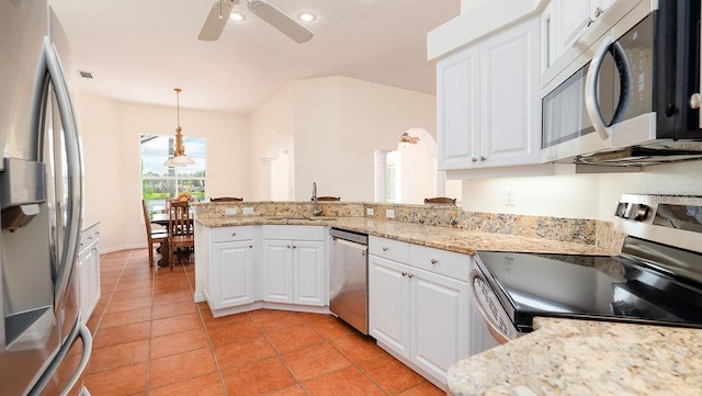 kitchen featuring pendant lighting, ceiling fan, stainless steel appliances, and white cabinets