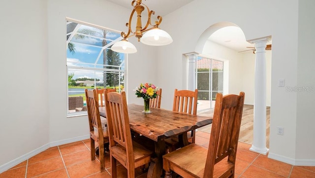 dining space featuring light tile patterned floors and ornate columns