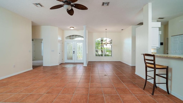 interior space featuring ceiling fan and light tile patterned floors