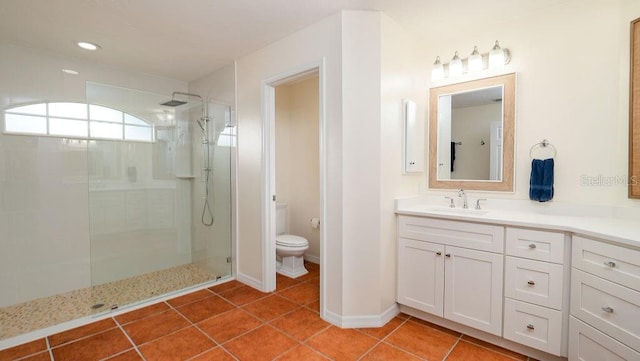 bathroom with vanity, toilet, tile patterned floors, and an enclosed shower