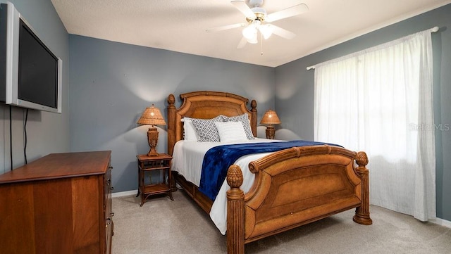 bedroom featuring light carpet and ceiling fan