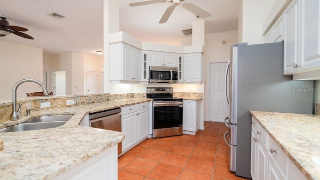 kitchen with appliances with stainless steel finishes, sink, ceiling fan, and white cabinets