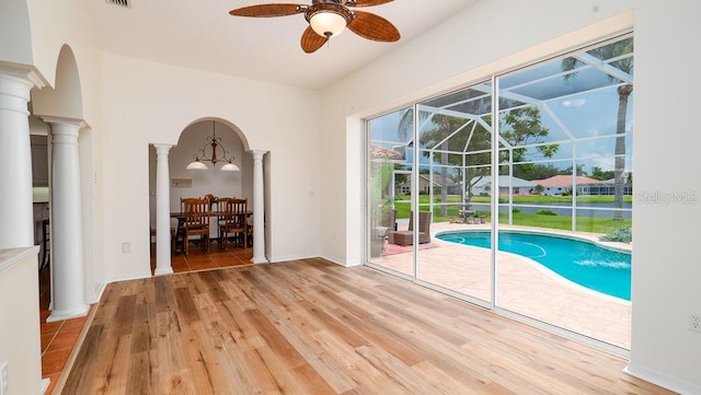 view of pool featuring decorative columns and ceiling fan