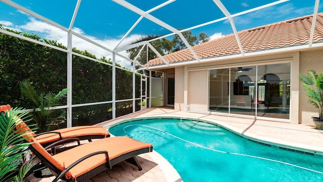 view of pool with a patio and glass enclosure