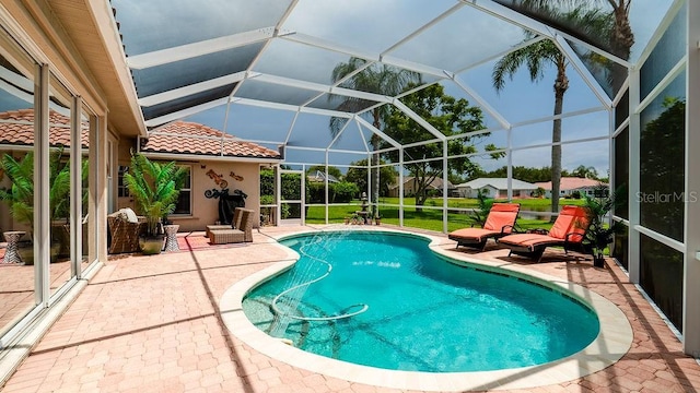 view of swimming pool featuring a lanai and a patio area