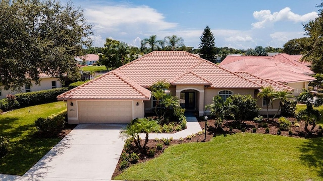 mediterranean / spanish-style home featuring a garage and a front yard