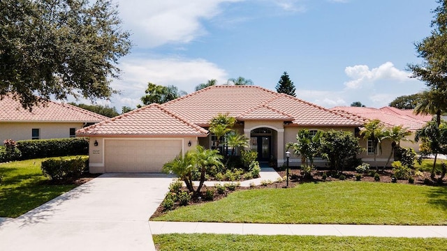 mediterranean / spanish house featuring a front yard and a garage