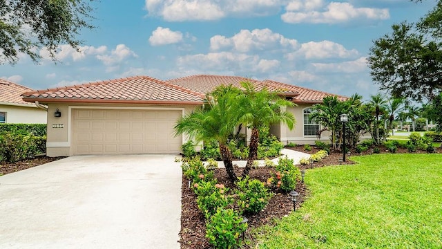 mediterranean / spanish home featuring a garage and a front lawn