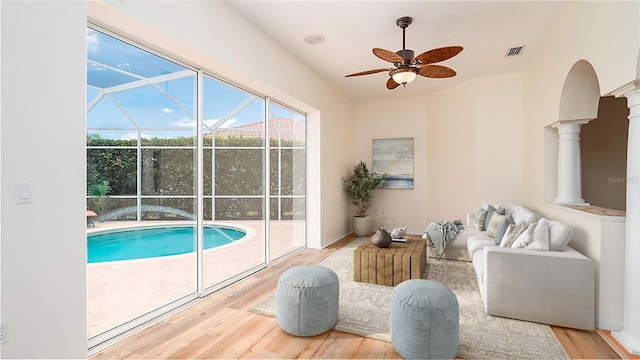 view of swimming pool featuring decorative columns and ceiling fan