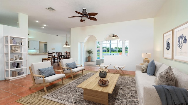 living room with tile patterned flooring and ceiling fan