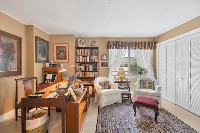 office featuring a textured ceiling and baseboards