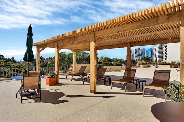 view of patio with a city view and a pergola