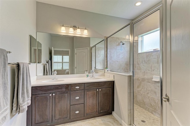 bathroom with an enclosed shower, plenty of natural light, and vanity