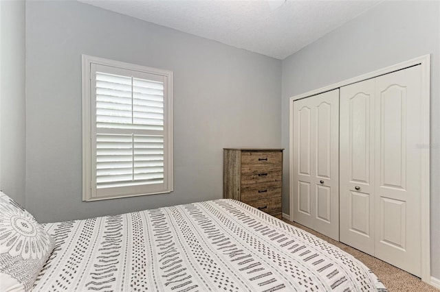 carpeted bedroom with a closet