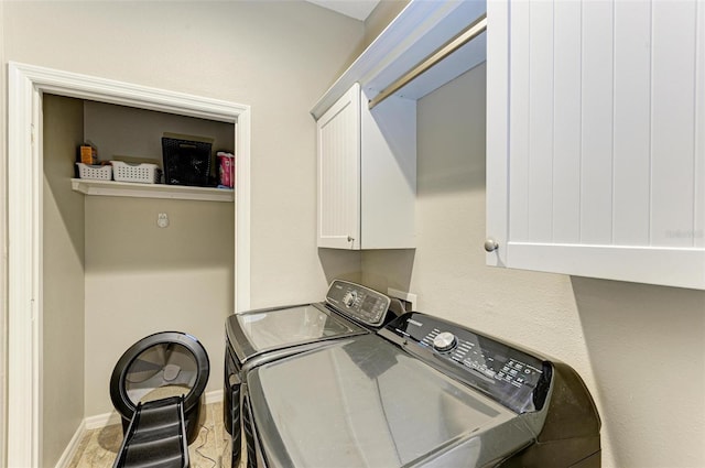 laundry room with cabinets and washer and dryer