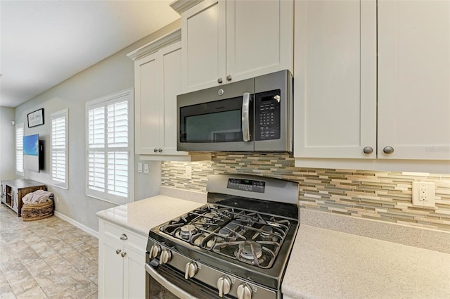 kitchen featuring white cabinetry, stainless steel appliances, and tasteful backsplash