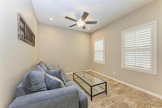 living room with ceiling fan and light hardwood / wood-style floors