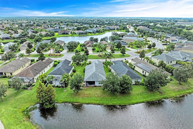 drone / aerial view featuring a residential view and a water view