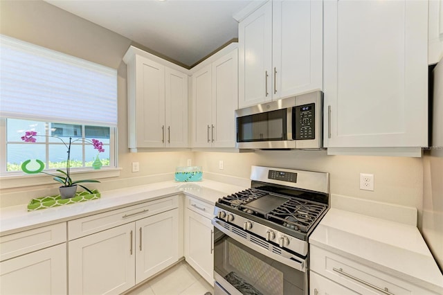 kitchen featuring white cabinetry, appliances with stainless steel finishes, and light tile patterned floors