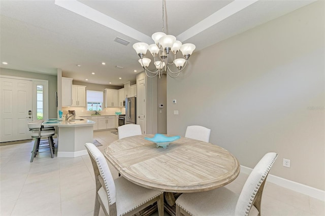 tiled dining area featuring a notable chandelier