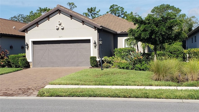 view of front of property featuring a garage and a front lawn