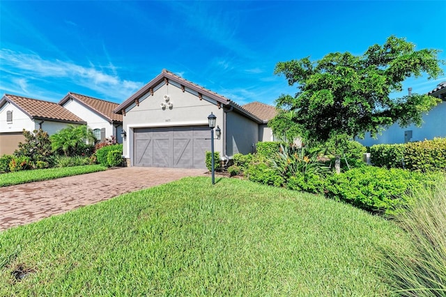 view of front facade with a garage and a front lawn