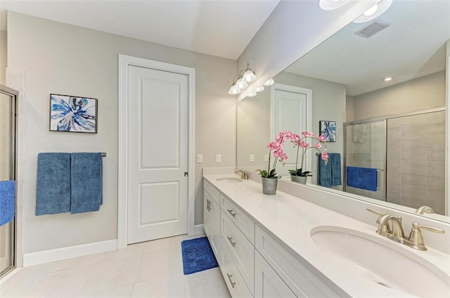 bathroom featuring vanity, tile patterned floors, and walk in shower