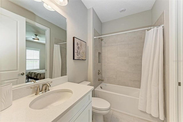 full bathroom with tile patterned floors, toilet, a textured ceiling, vanity, and shower / bath combo