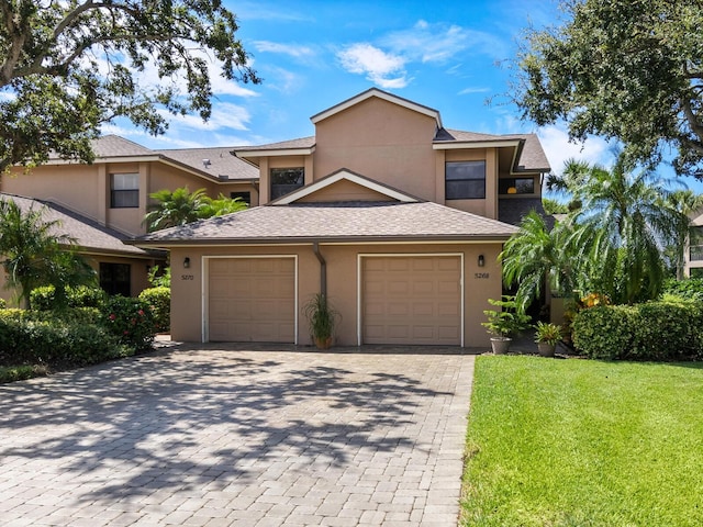 view of front of house featuring a front yard and a garage