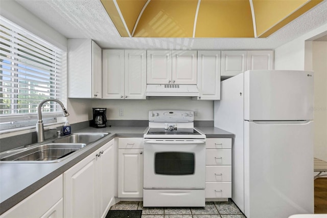 kitchen featuring custom range hood, white cabinetry, light tile patterned floors, sink, and white appliances