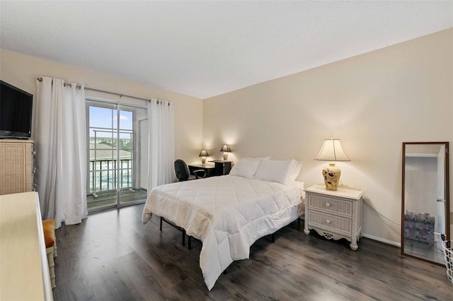 bedroom with access to outside and dark hardwood / wood-style floors