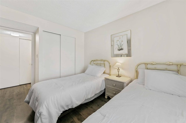 bedroom featuring a closet and dark wood-type flooring