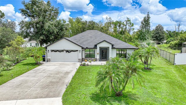 view of front facade with a front yard and a garage