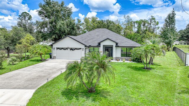 view of front facade with a front yard and a garage