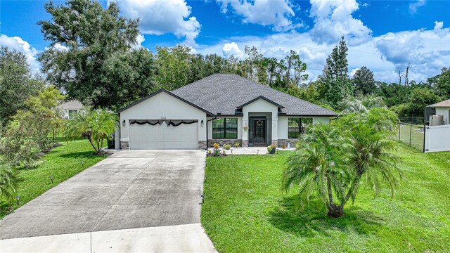 view of front of home featuring a garage and a front yard