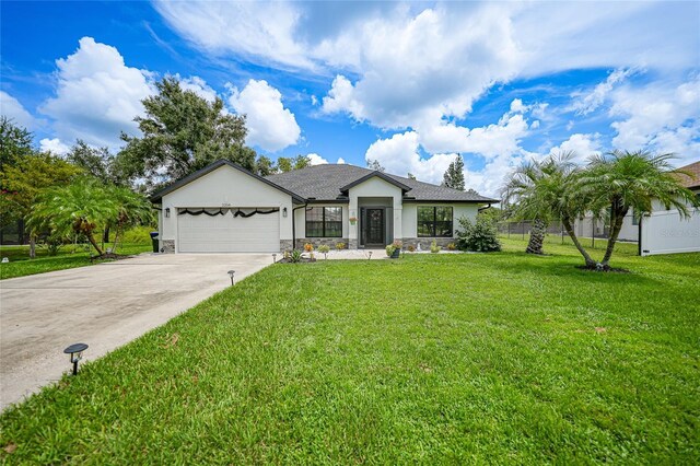 view of front of home with a garage and a front lawn