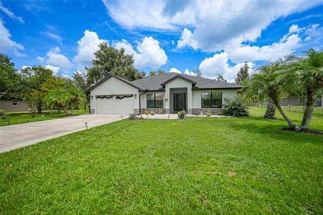 single story home with a garage and a front lawn