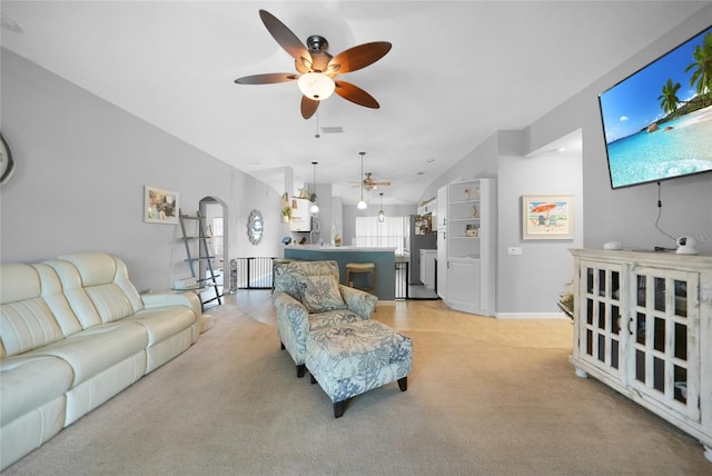 living room featuring light colored carpet and vaulted ceiling